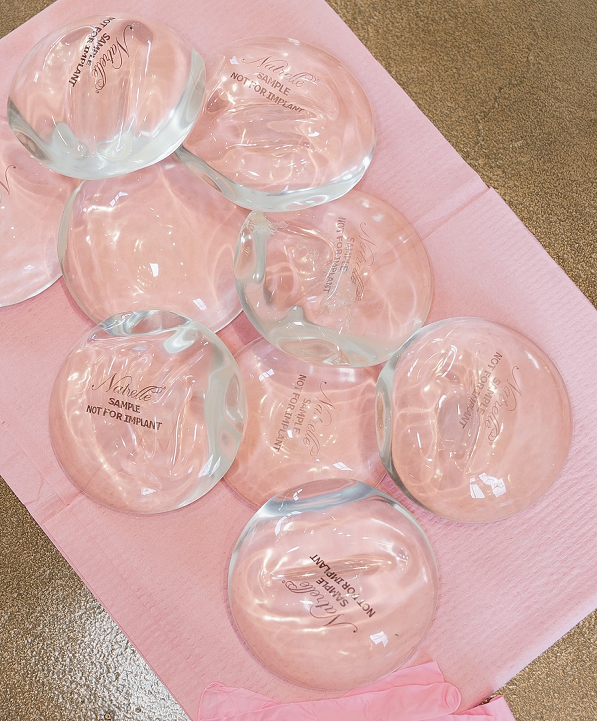 Silicone breast implant samples on pink background