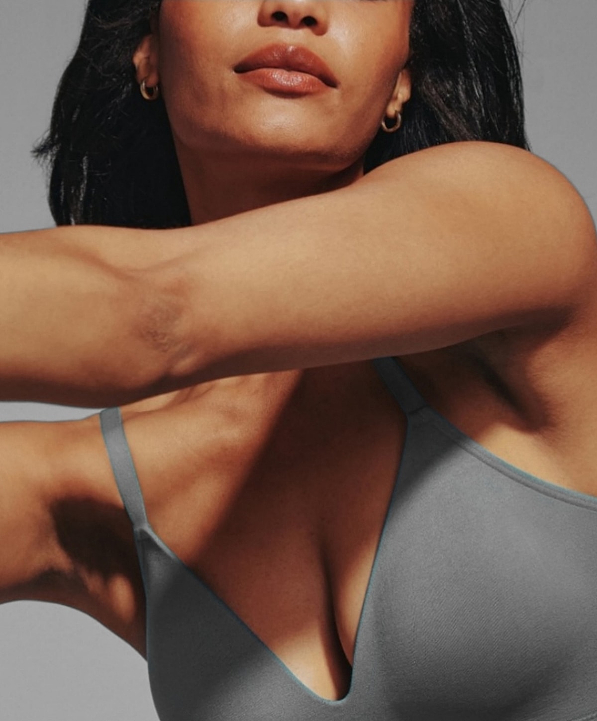 Model wearing a gray tank top close-up.