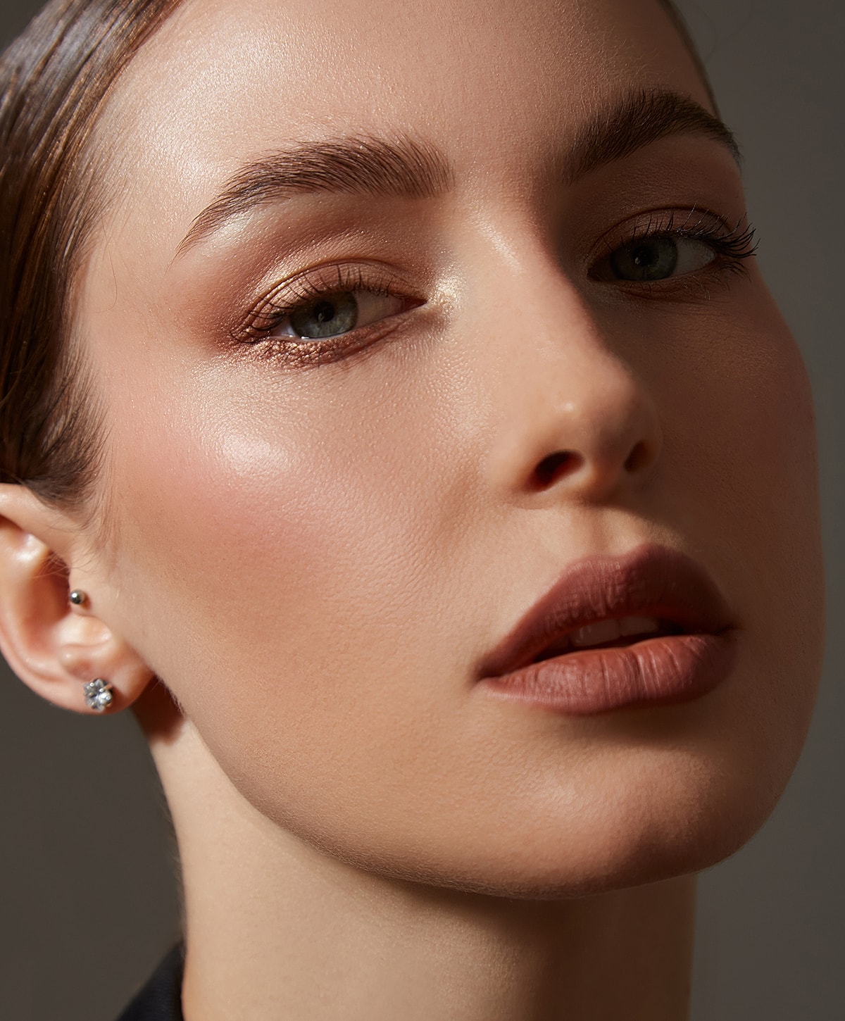 Close-up of a woman's face with natural makeup.