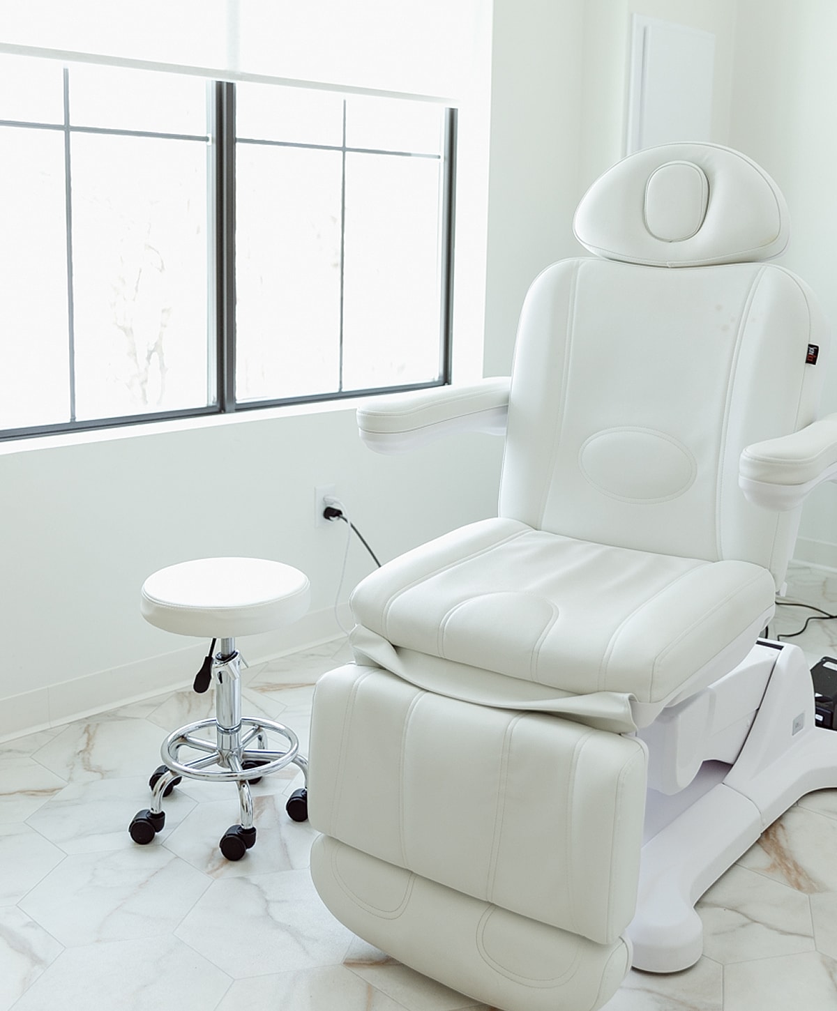 Modern white treatment chair in bright room