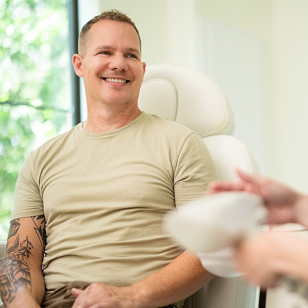 Man smiling during a consultation session.