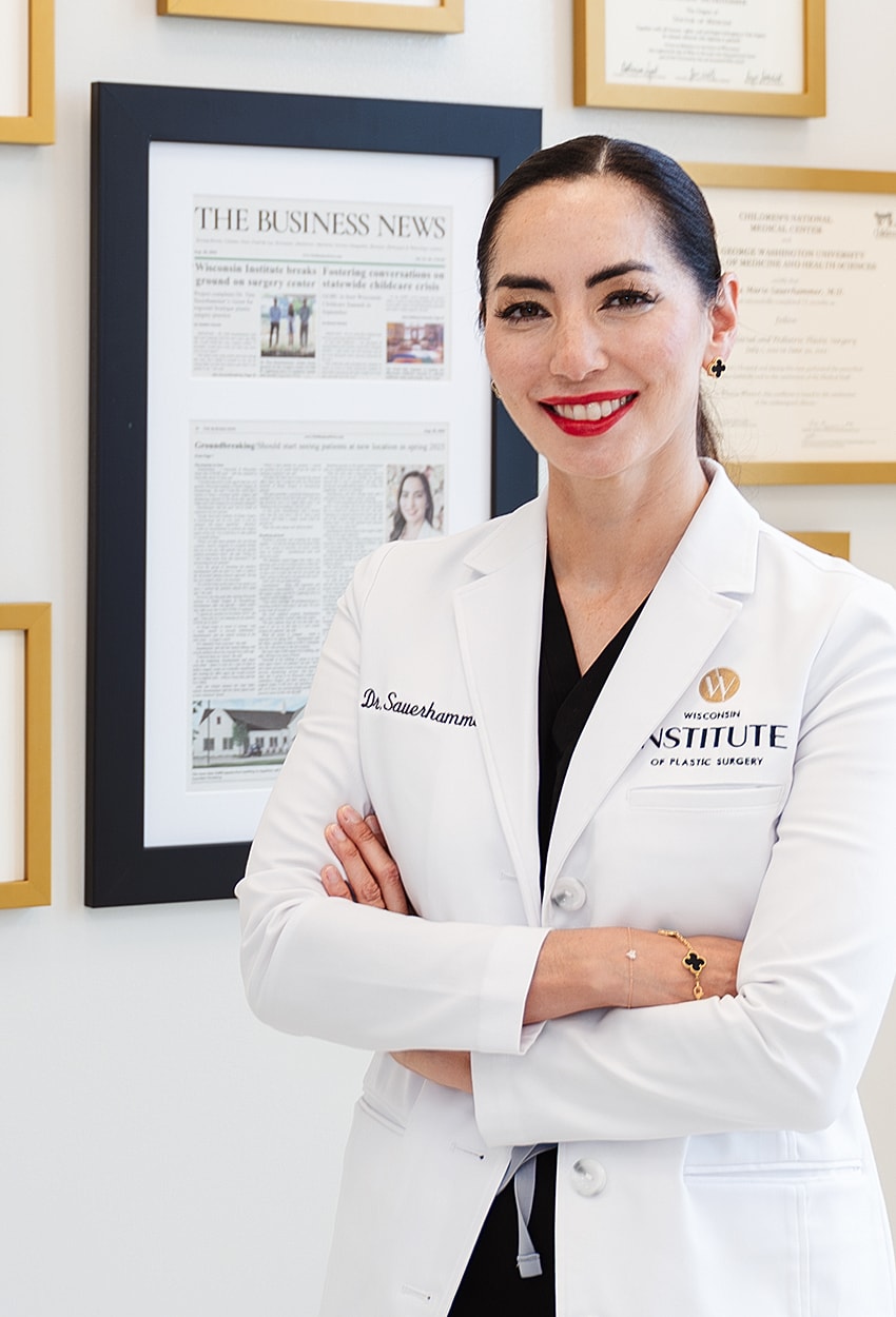Female doctor in a lab coat smiling confidently.