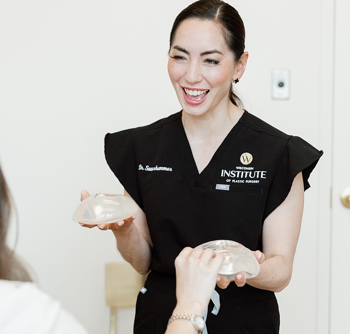 Doctor discussing breast implants with patient.