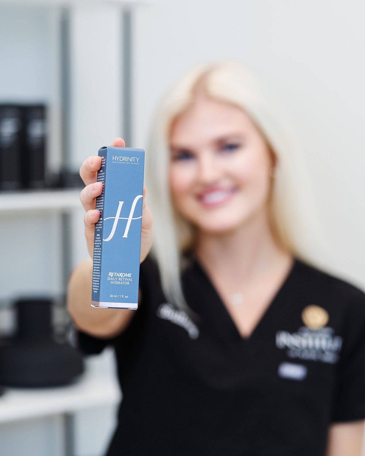 Person holding Hydrinity retinol product in studio.