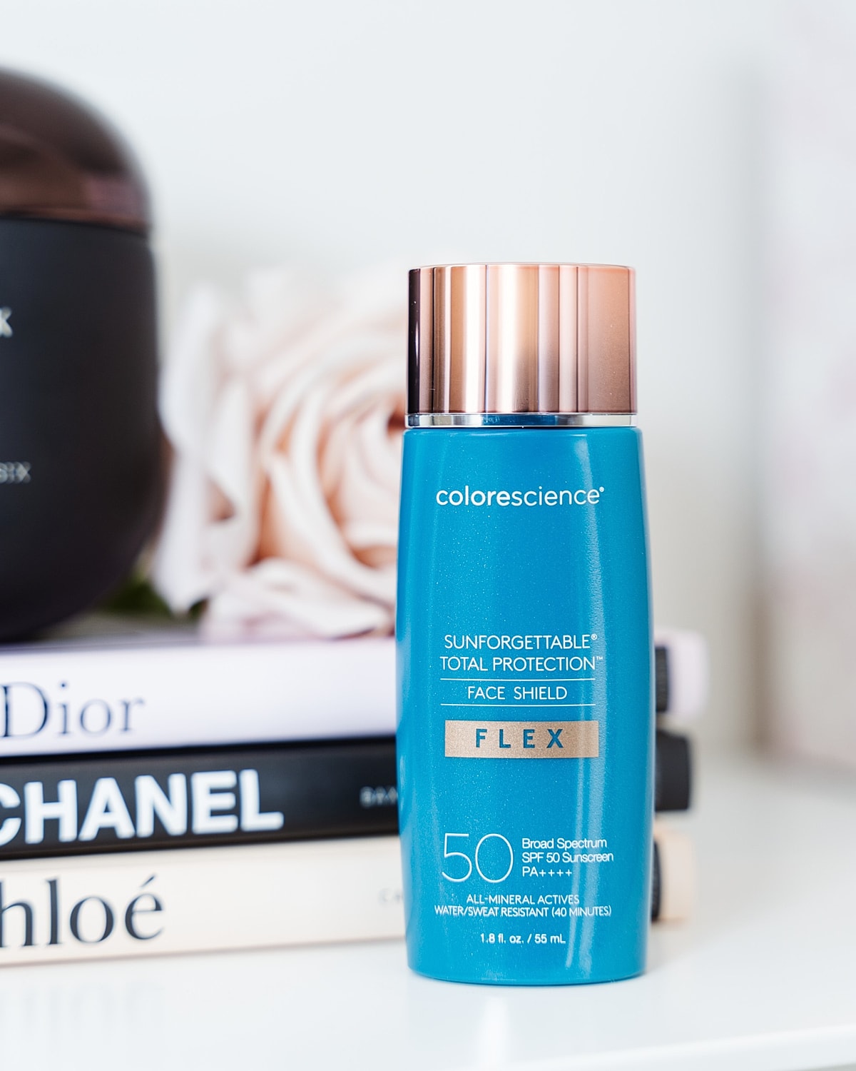 Colorescience face sunscreen on stylish books.