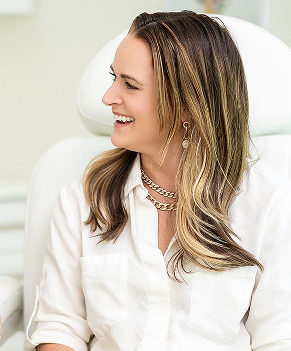 Smiling woman in a bright, professional setting.