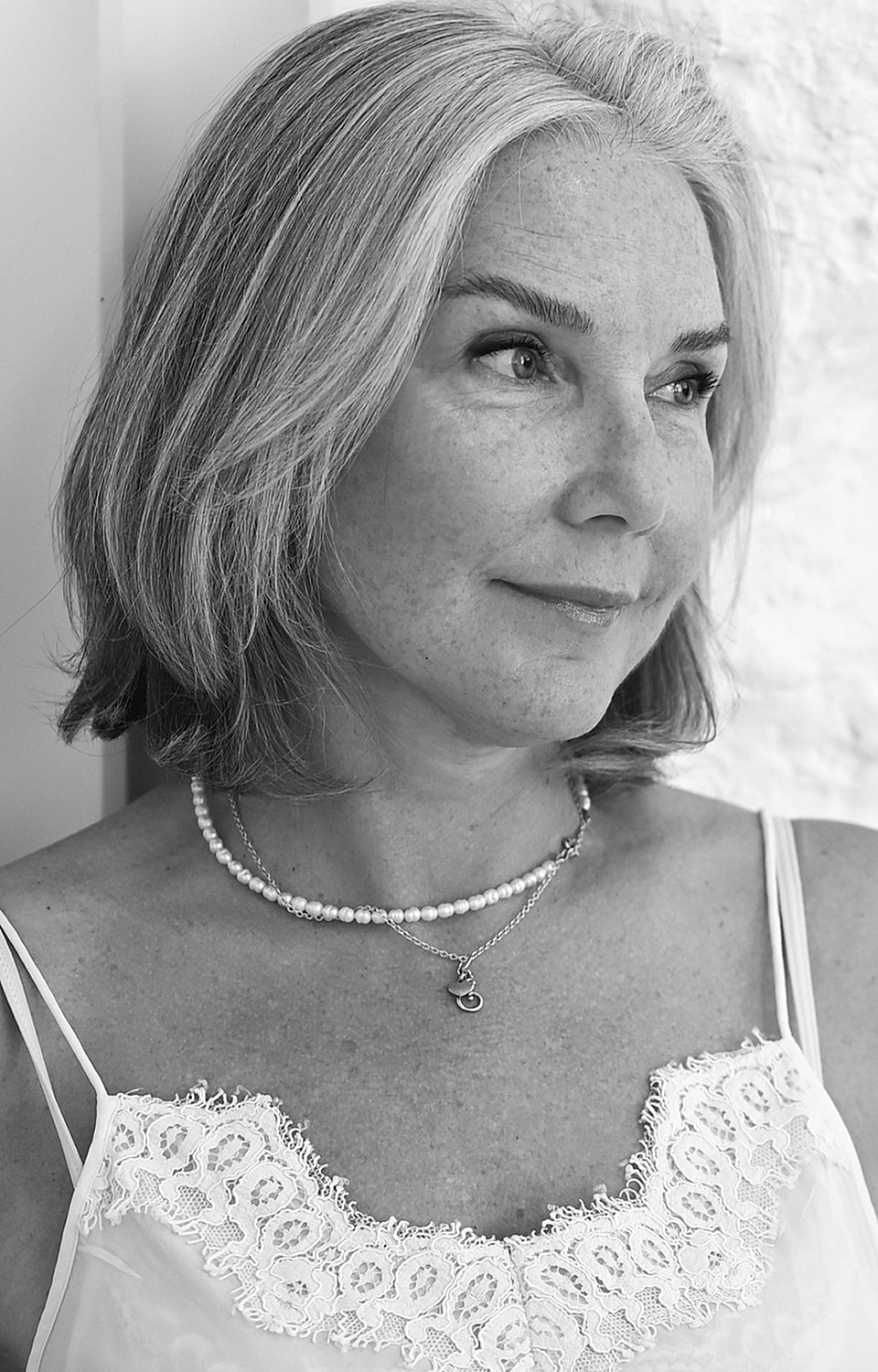 Woman with gray hair in black and white portrait.