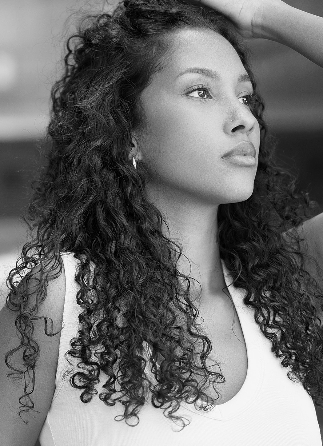 Young woman with curly hair in black and white.