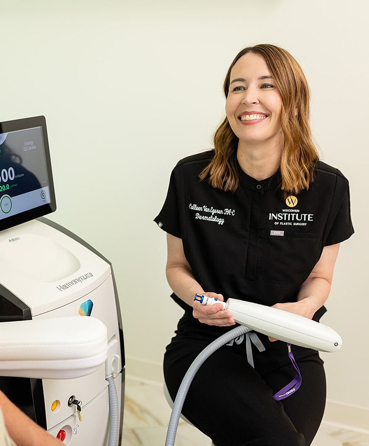 Dermatology professional with laser treatment equipment.