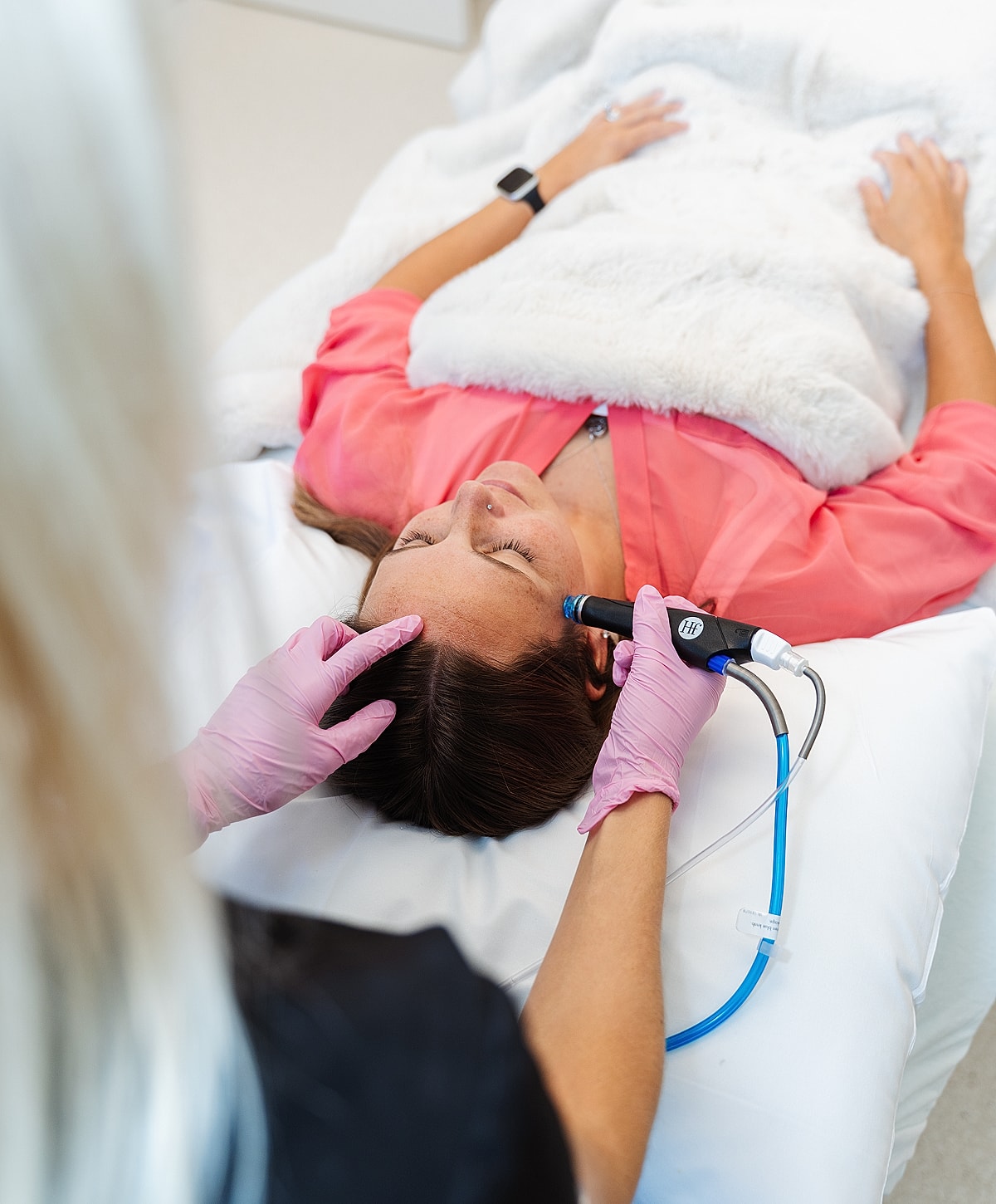 Woman receiving a skincare treatment in a clinic.