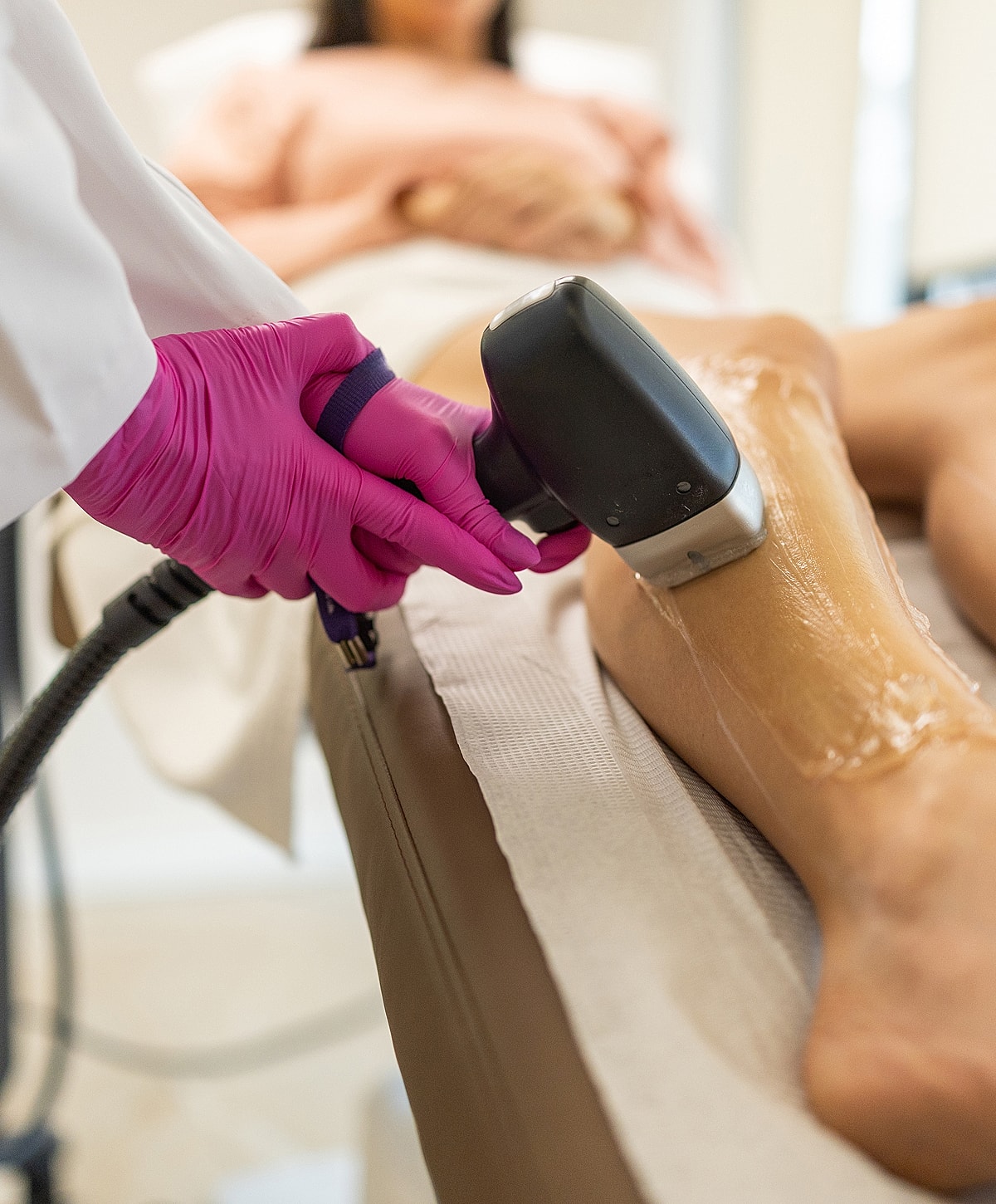 Laser hair removal treatment in progress on leg.