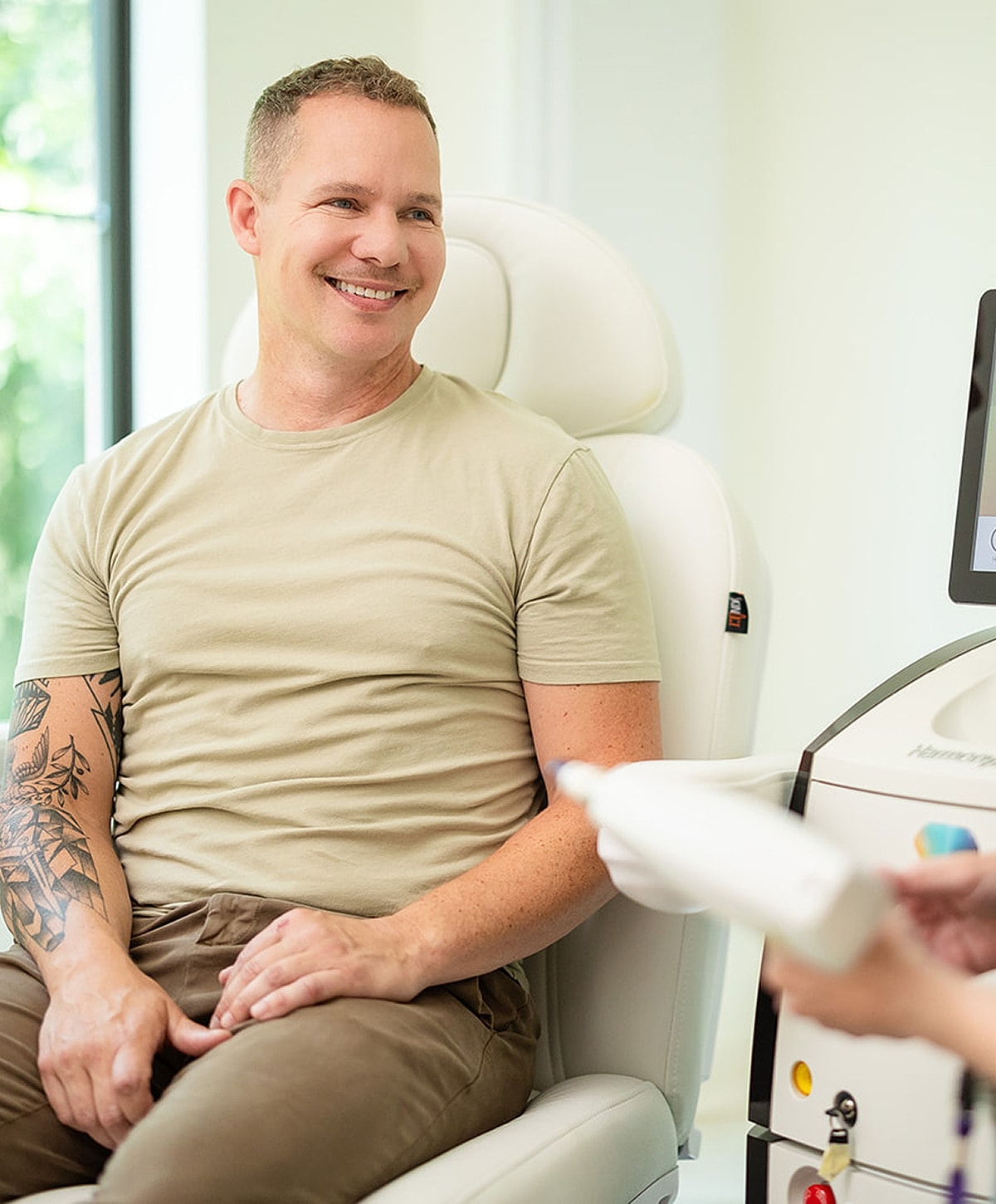 Patient smiling during a cosmetic treatment consultation.