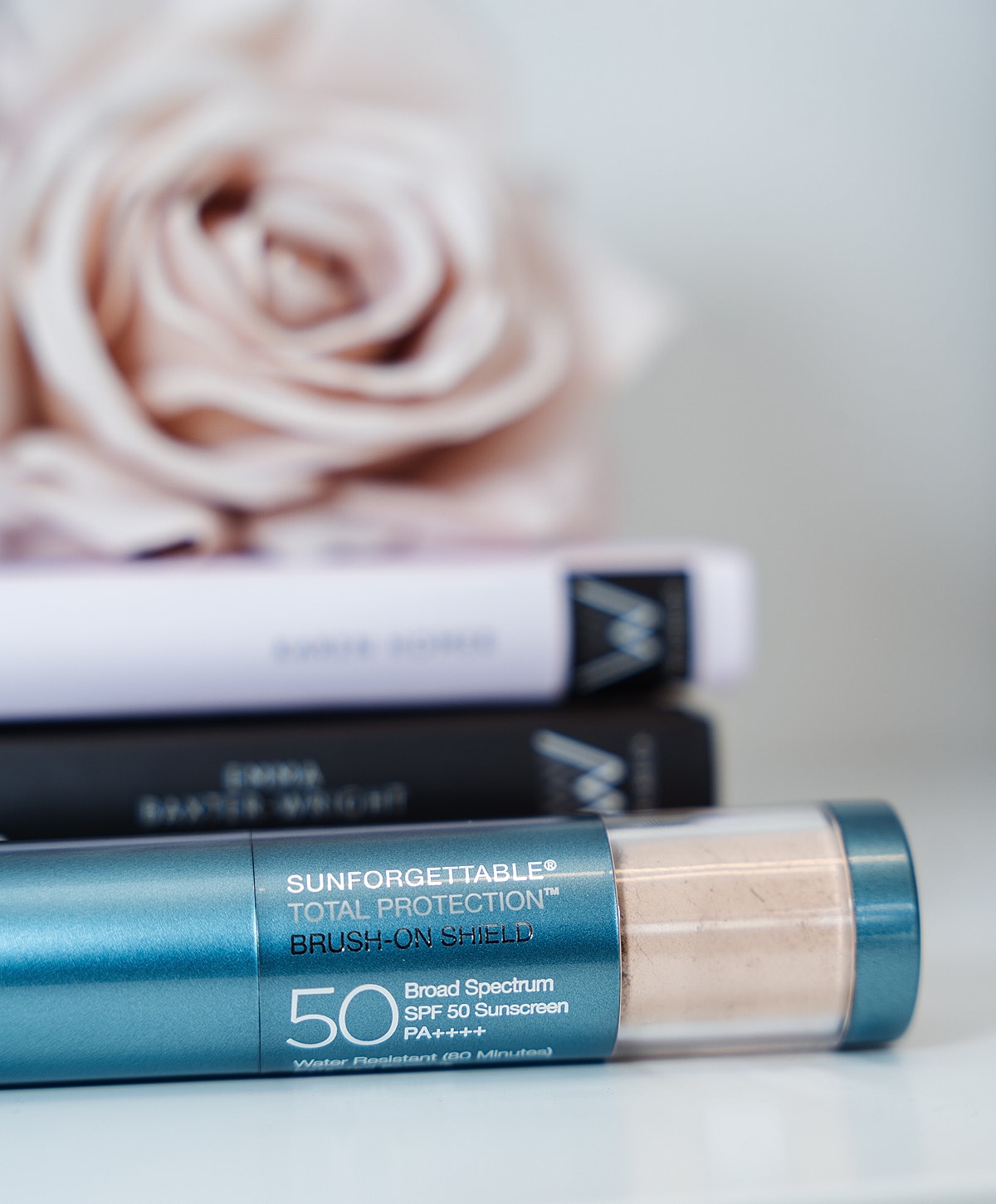 Sunscreen product with books and a rose.