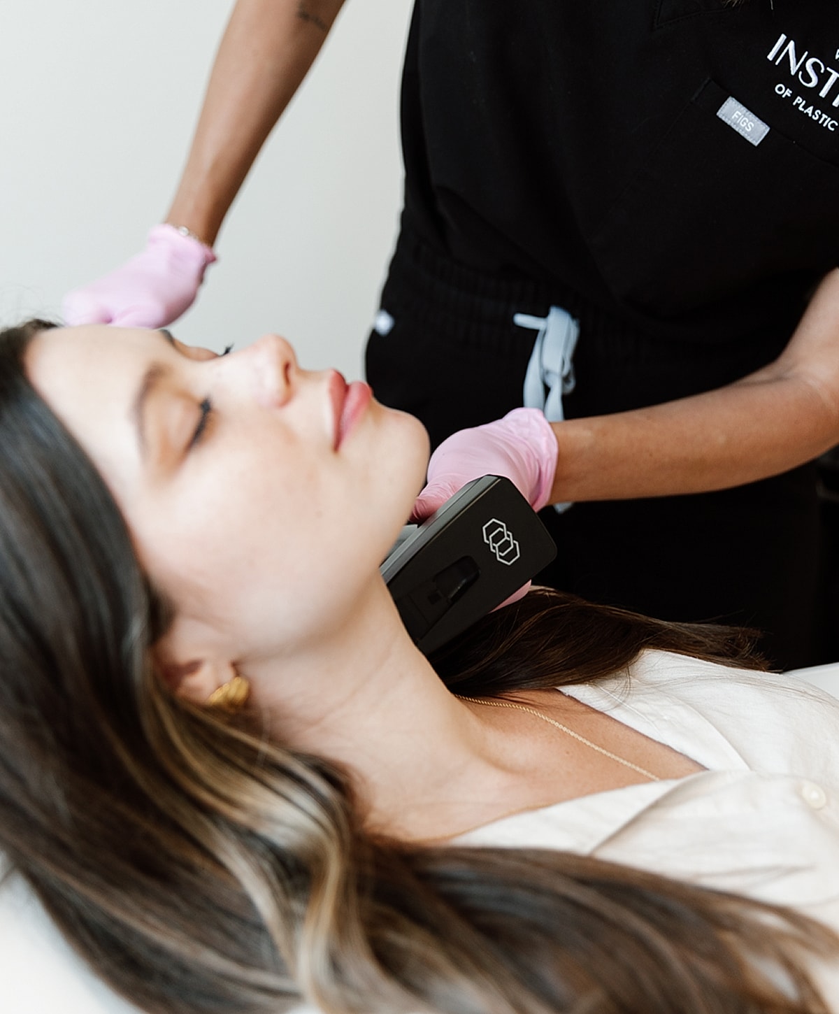 Woman receiving a skincare treatment in clinic.