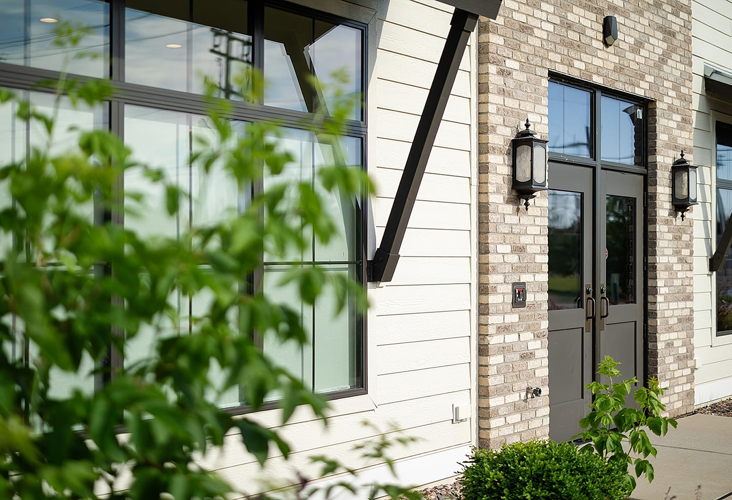 Modern building entrance with greenery accents.