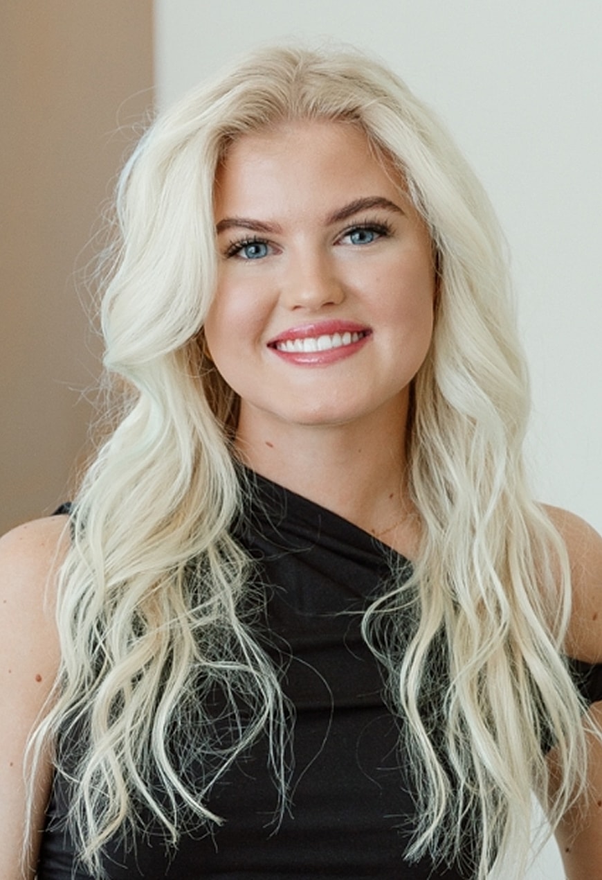 Smiling woman with long blonde hair and black dress