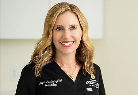 Smiling dermatologist in medical attire.