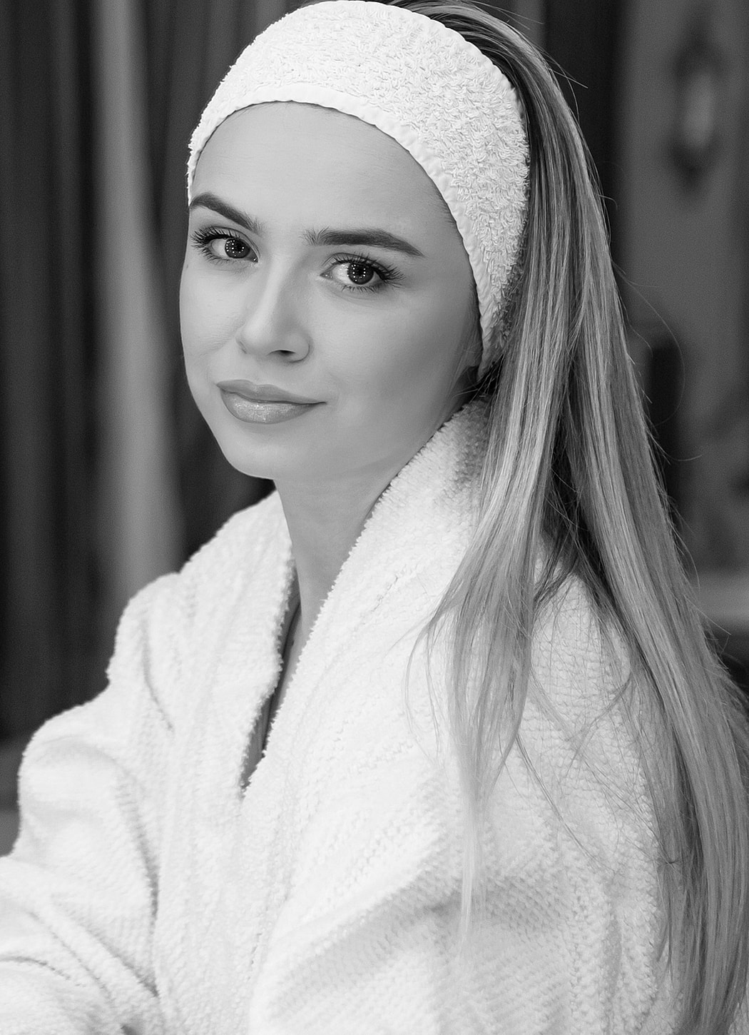 Woman in bathrobe with headband, black and white.