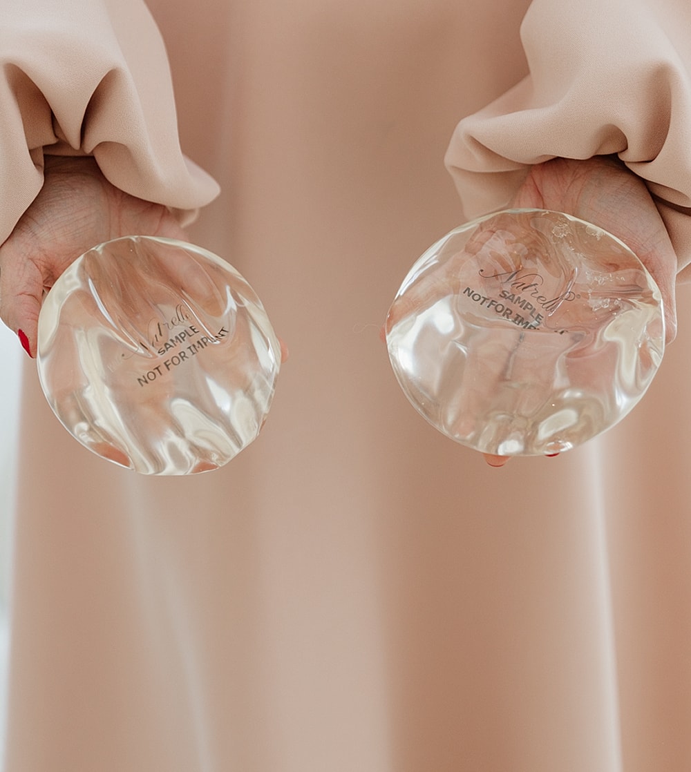 Two glass plates held by a person.