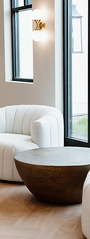 Modern lounge area with white couches and table