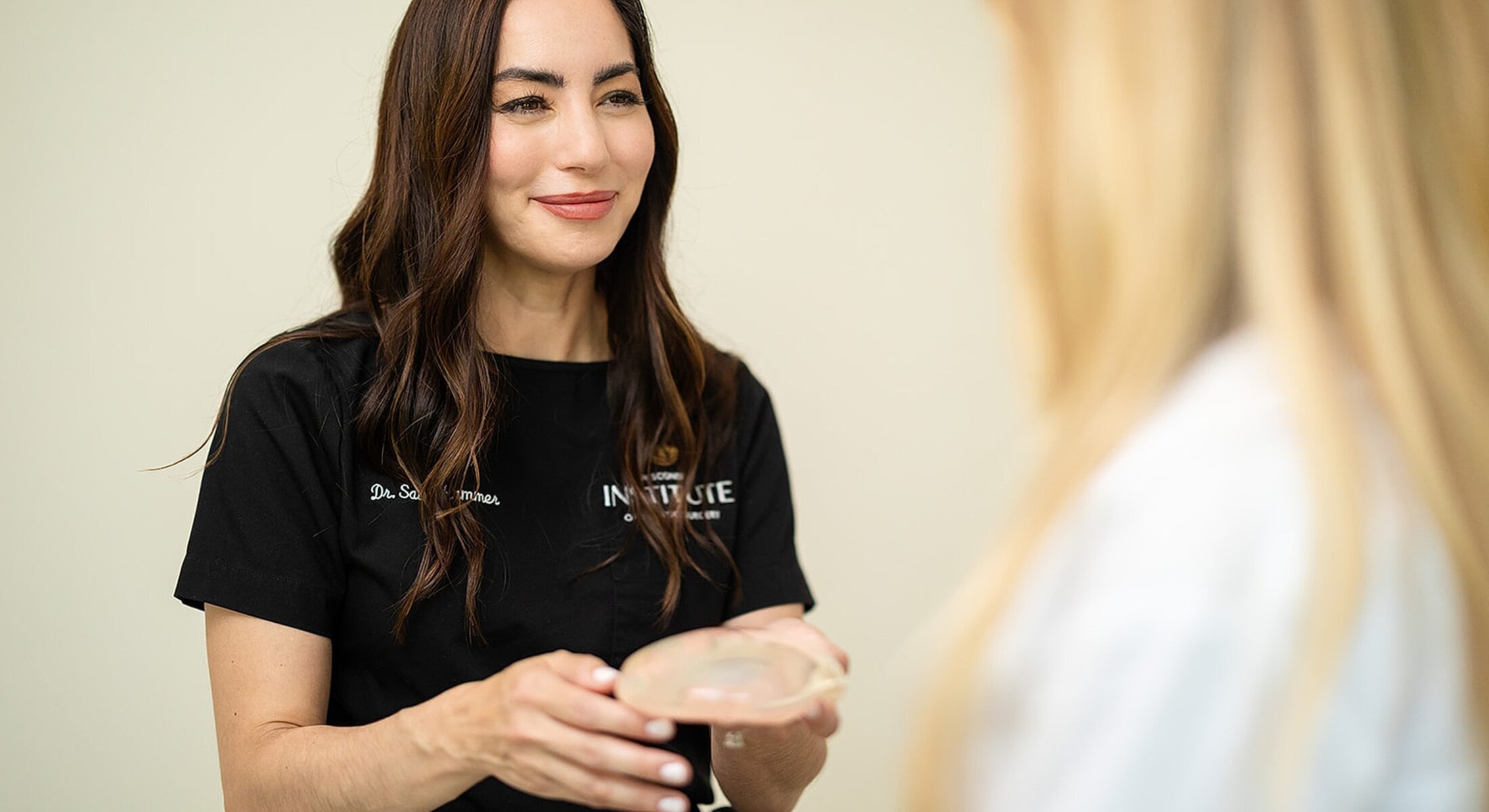 Doctor discussing breast implants with a patient.