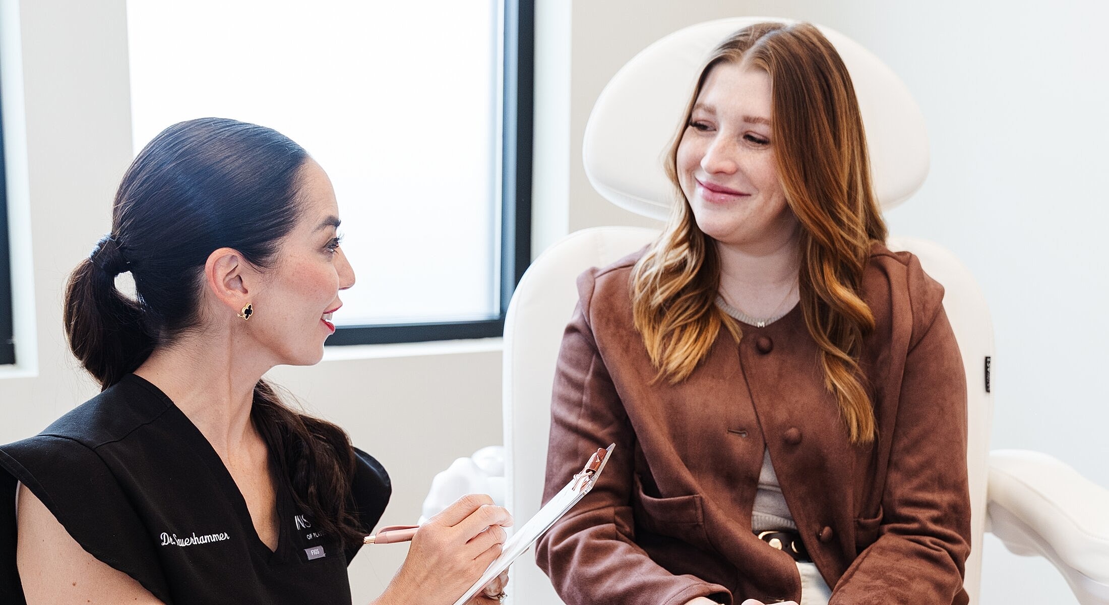 Consultation between a client and aesthetician.