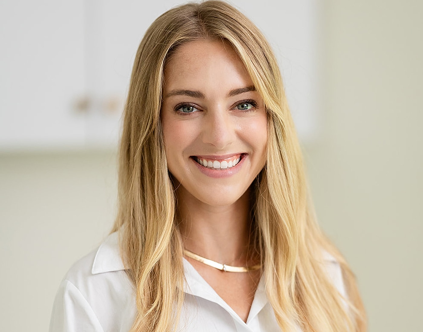 Smiling woman in professional attire.