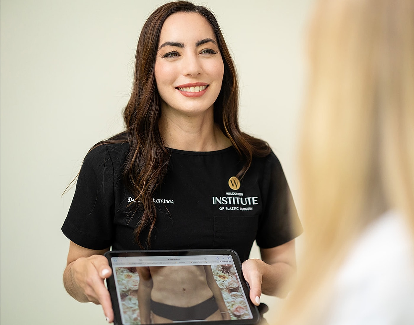 Plastic surgeon discussing procedure with patient.