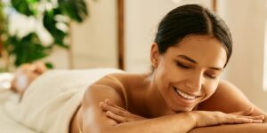 young woman resting and looking down with eyes closed after a microneedling treatment